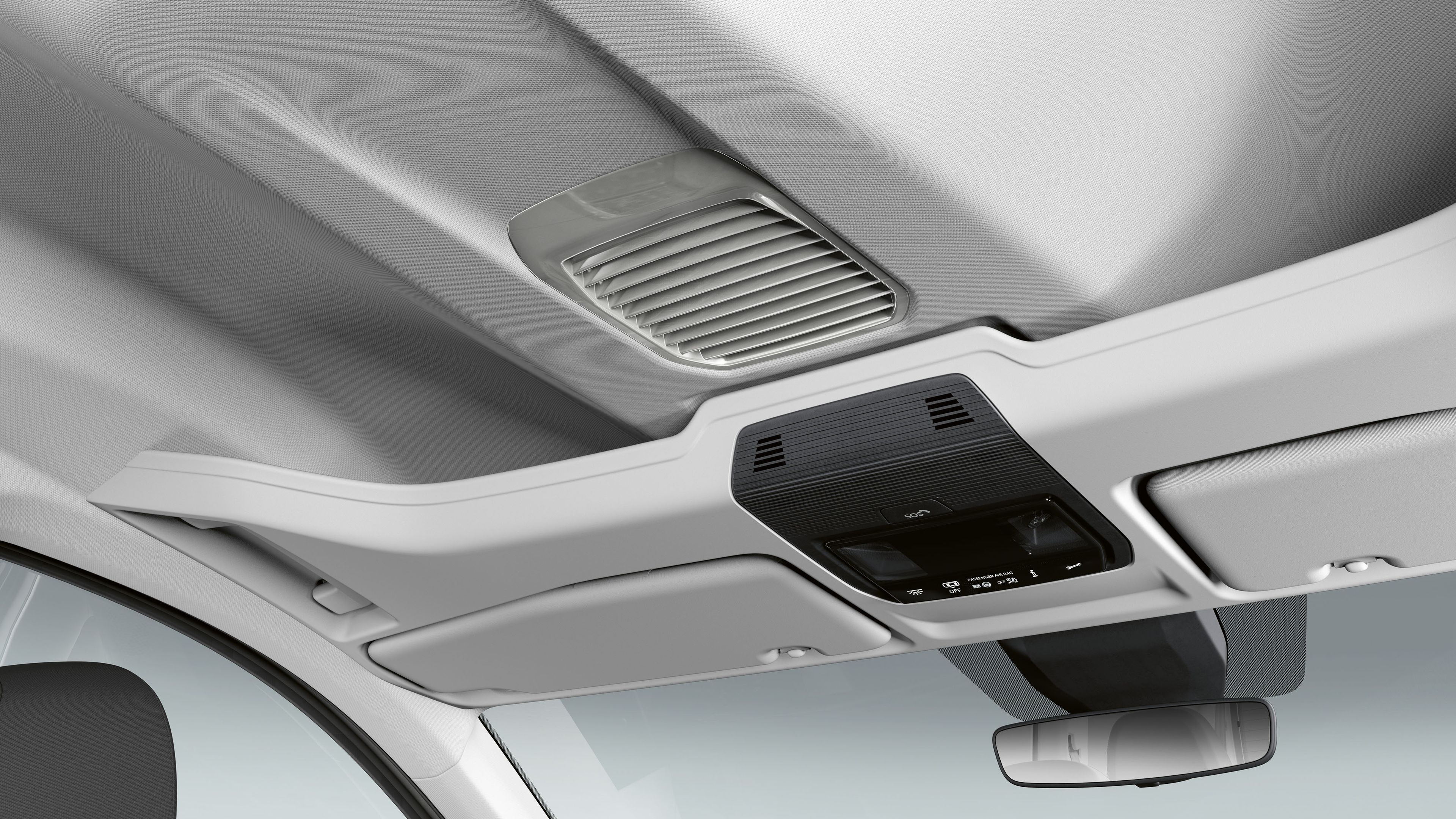 Stropný panel v automobile obsahujúci s osvetlením a ovládacími prvkami klimatizácie. Súčasťou je vnútorné spätné zrkadlo. Panel má bielu farbu a jednoduchý dizajn.